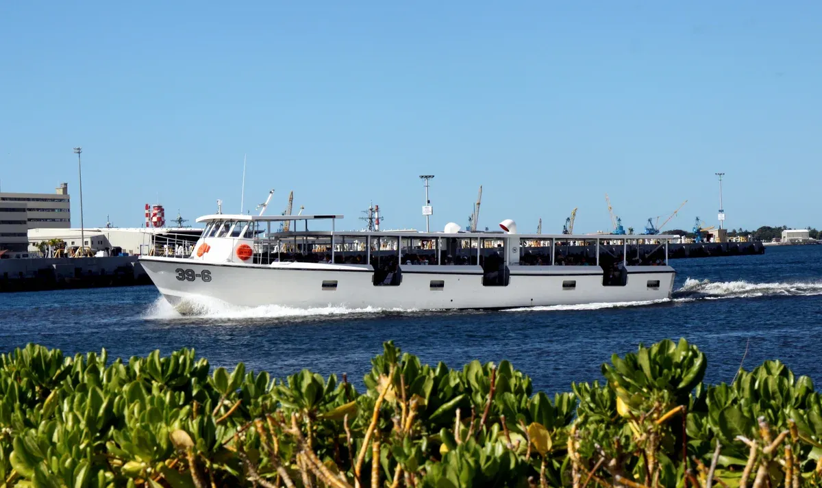 The white navy shuttle boat (no. 39-6) crossing Pearl Harbor, the only way to reach the USS Arizona Memorial, seen on Pearl Harbor tours from Honolulu