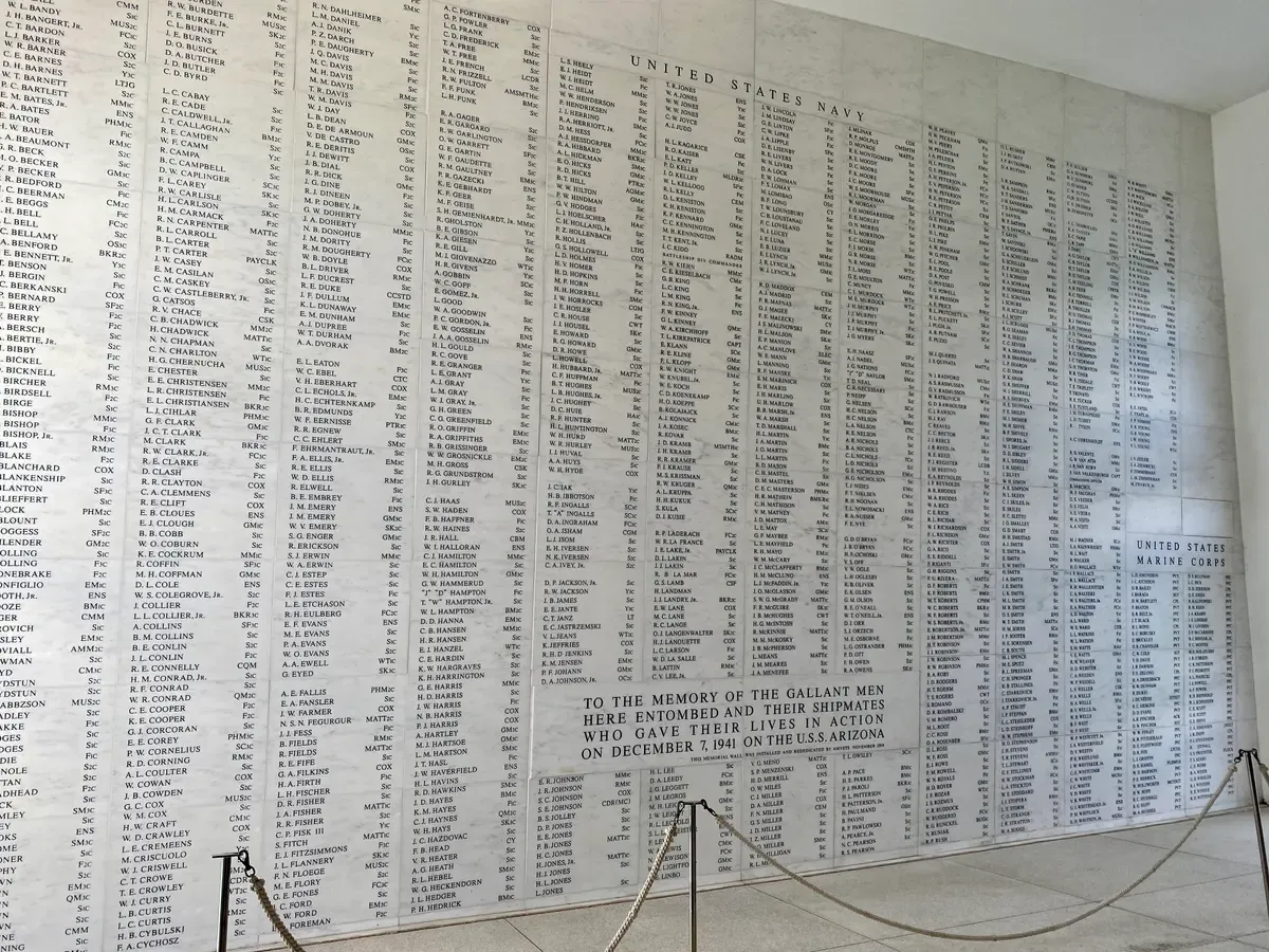 The marble memorial wall in the shrine room of the USS Arizona Memorial, listing the names of the Arizona crew who died on December 7, 1941, seen on Pearl Harbor tours from Honolulu